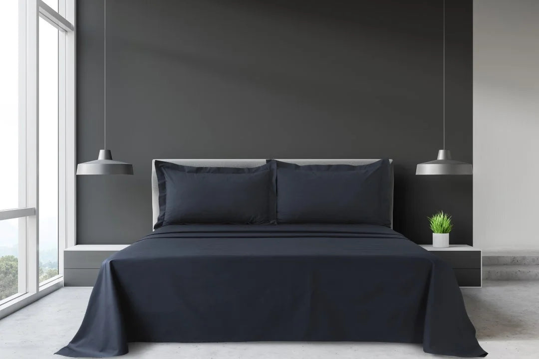 Grey King and Super King percale sheet set with matching pillowcases arranged on a large hotel-style bed.