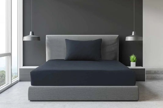 Grey Single and King Single percale fitted sheet displayed on an accommodation-style bed with a matching pillow.