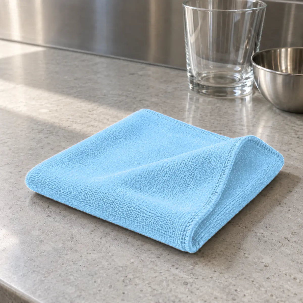 Light blue microfibre cleaning cloth 30 x 40 cm folded on a commercial kitchen bench NZ