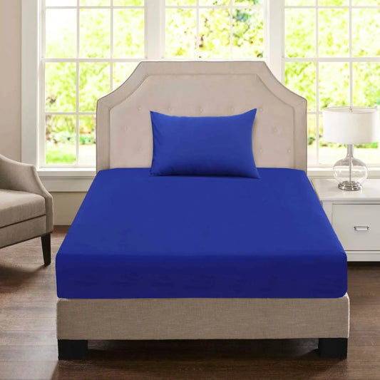 Navy blue King Single polycotton fitted sheet and matching pillowcase displayed on an accommodation-style bed.