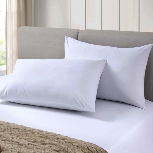 White percale pillowcases displayed on a hotel-style bed for commercial accommodation providers in New Zealand.