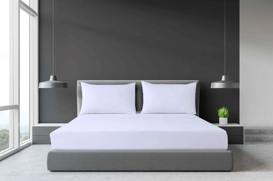 White Double and Queen percale fitted sheets displayed on a modern hotel-style bed with two white pillows.