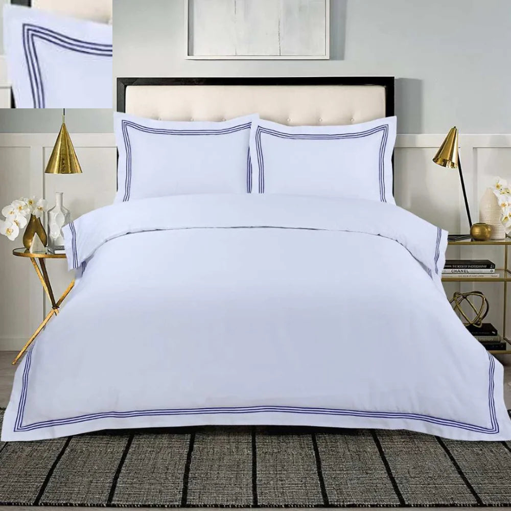 White 100% cotton duvet cover set with navy embroidered border and matching pillowcases.