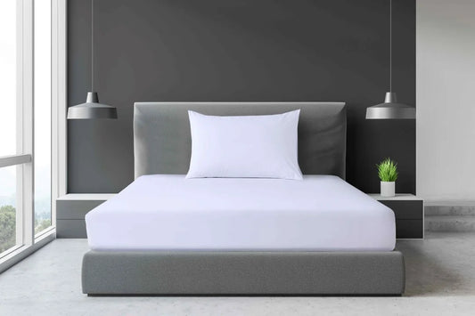 White Single and King Single percale fitted sheet displayed on a modern accommodation-style bed with a white pillow.